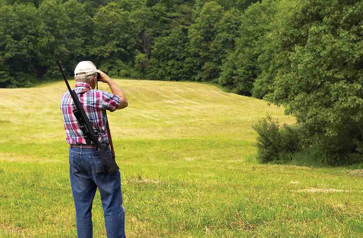 Stepping out from the tree line for a brief time allows the shooter to get the lay of the land while looking for any chuck dens along the edge of the field downrange.